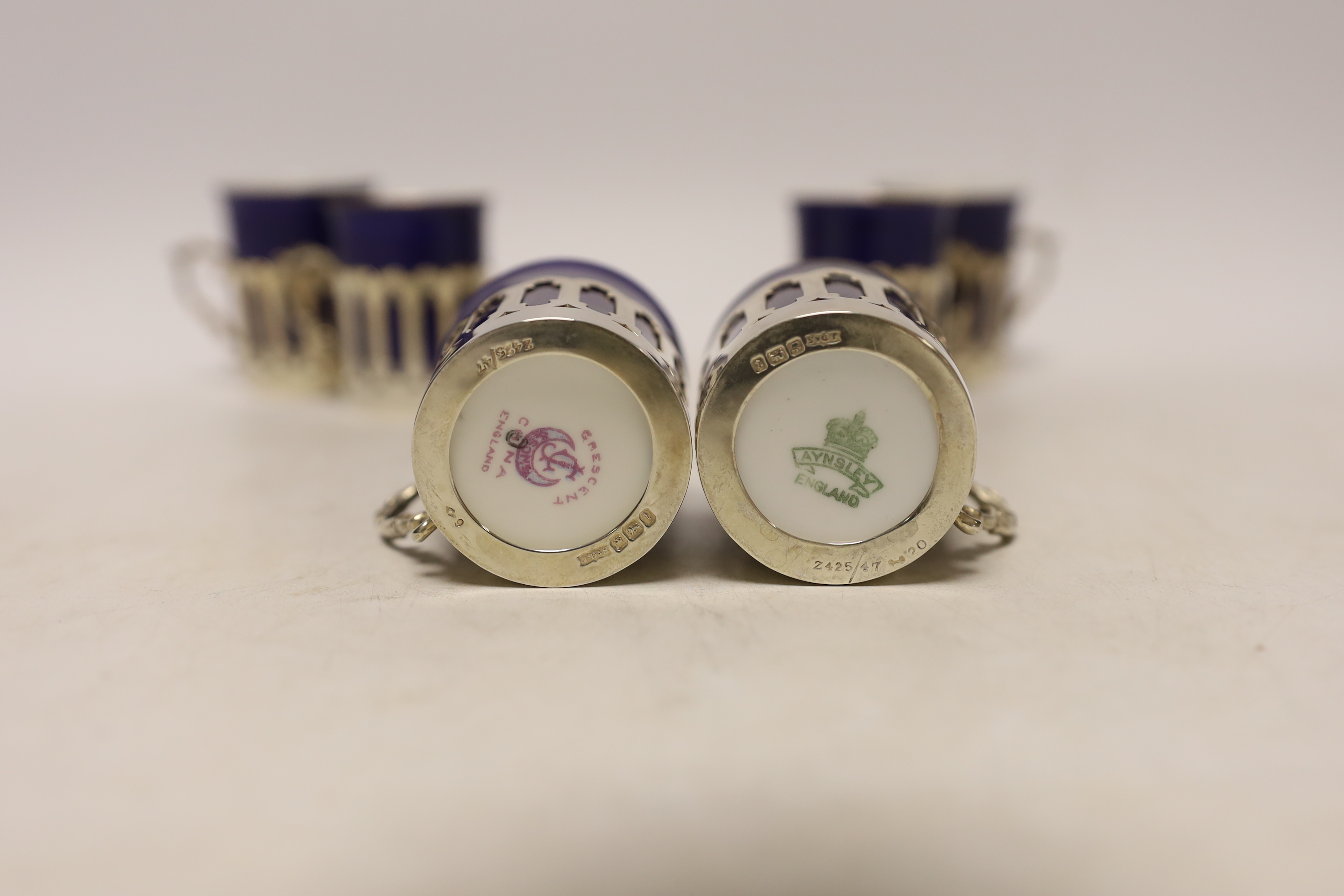 A set of six pierced silver handled coffee can holders, James Dixon & Sons, Sheffield, 1911, with six Crescent China coffee cans